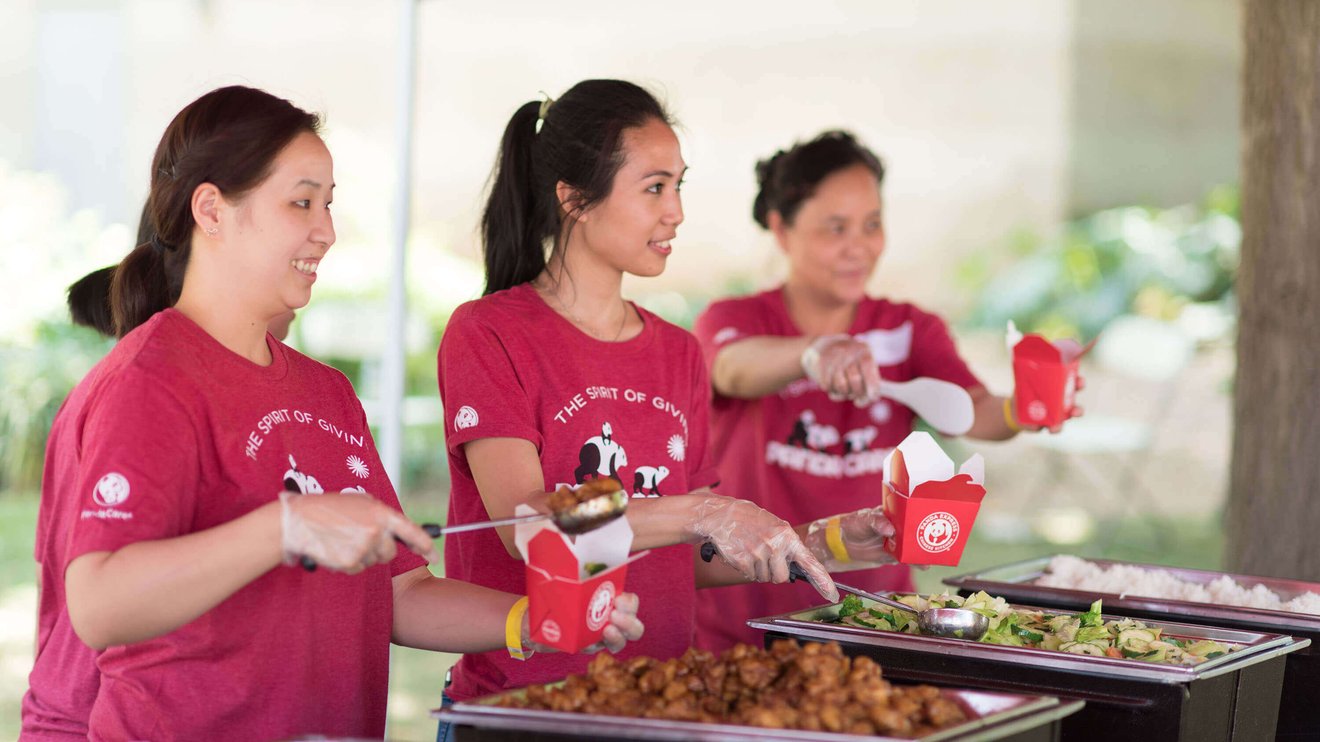 Panda Express members serving food